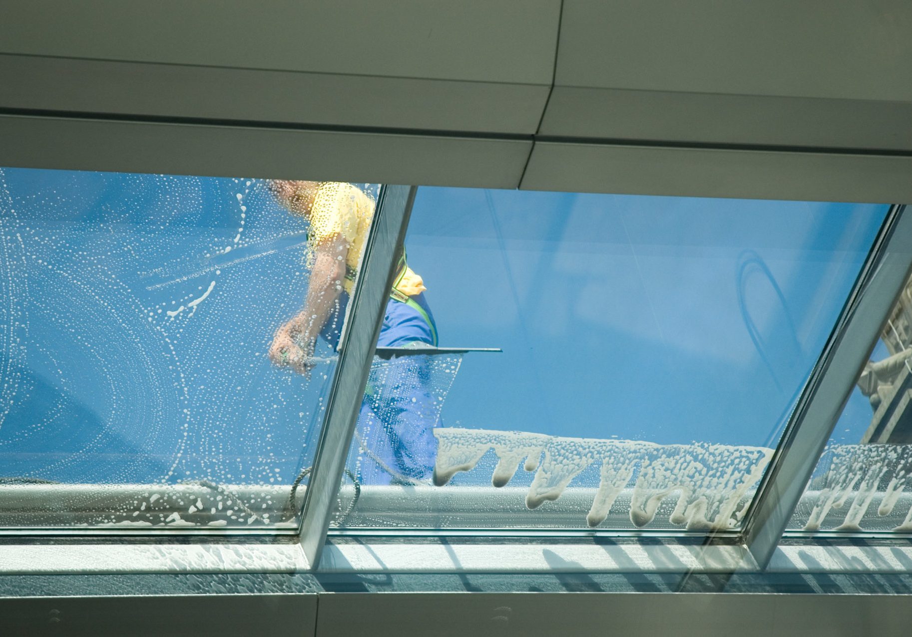 worker cleaning windows