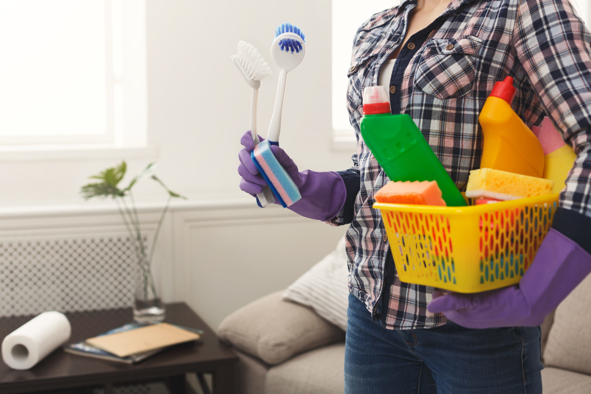 Unrecognizable woman with cleaning equipment ready to clean house. Professional cleaning service concept, copy space